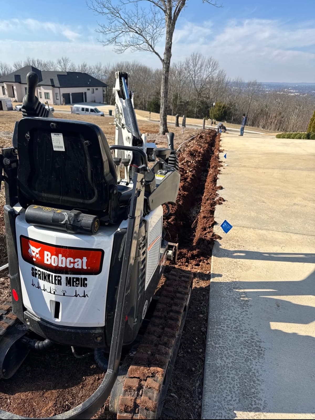 Sprinkler Medic Bobcat trenching for irrigation installation